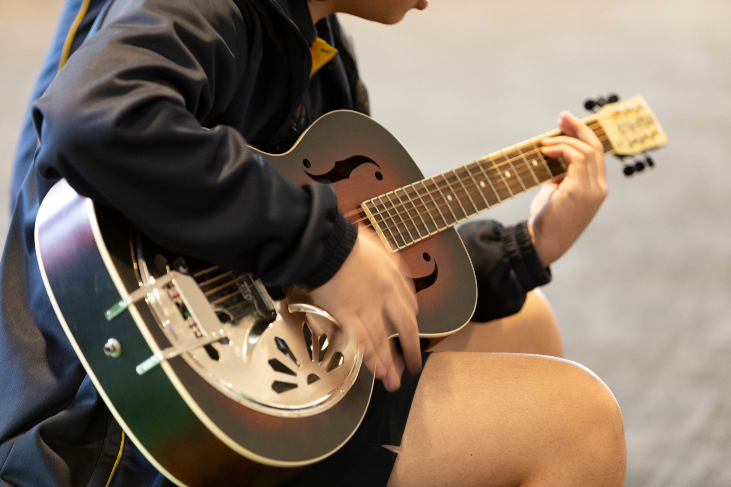 Student playing a guitar
