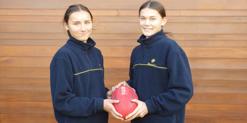 Twins-Mathilde-and-Zoe-Wilkinson-holding-football
