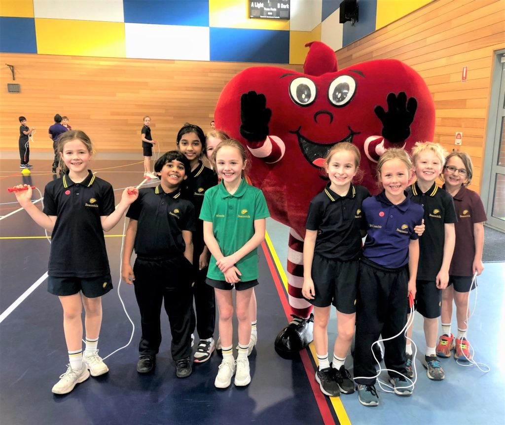 Group of students with skipping ropes and costumed heart character.