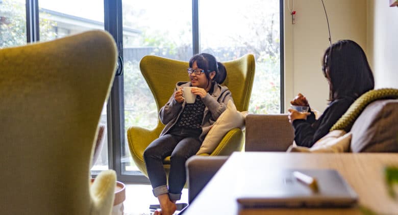 Girl sitting in chair in boarding house