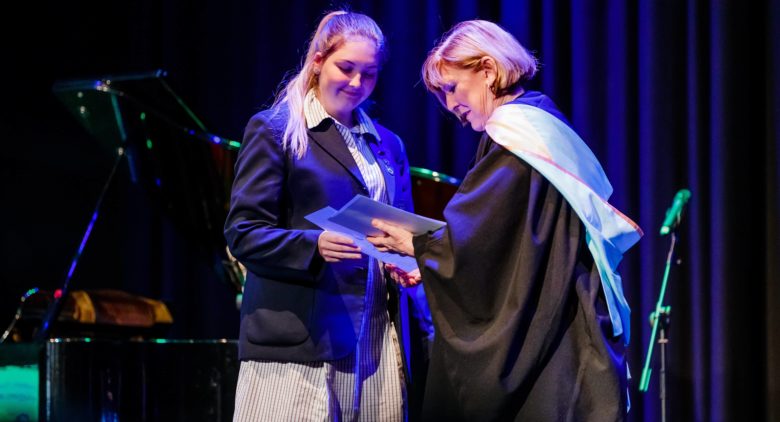 Teacher presenting an award to girl