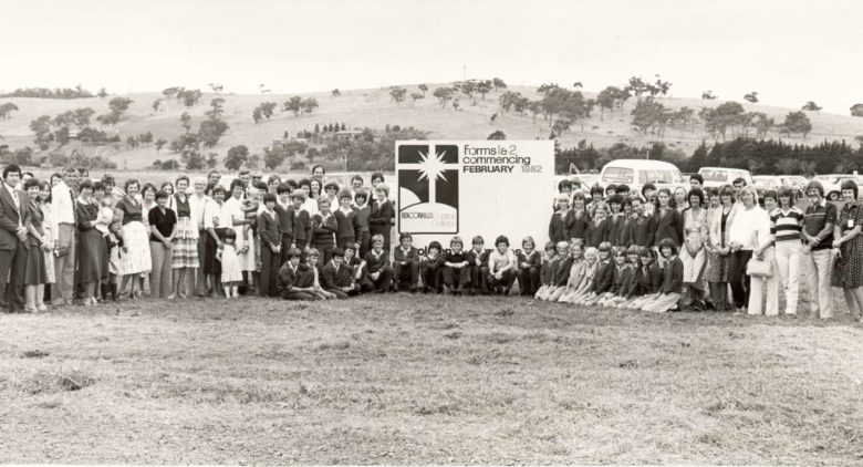 Group of staff and students outside on school opening day 1982