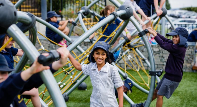 Junior school students playing on playground