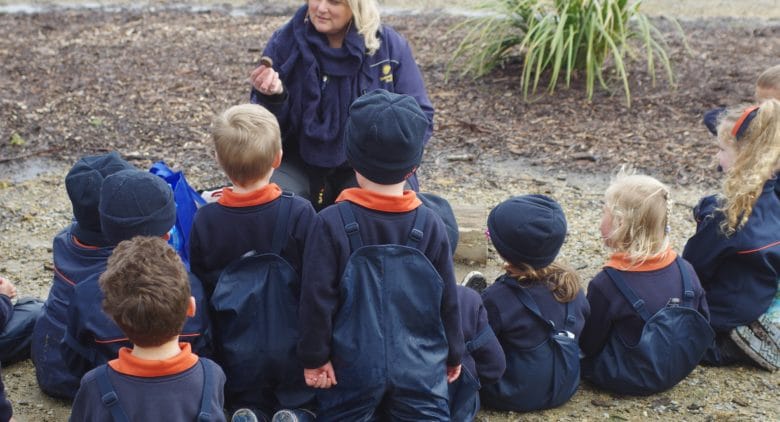 Indigenous educator Lynette George outside with children