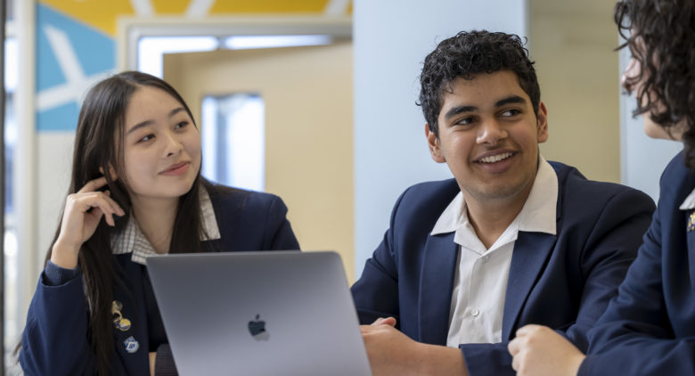 Girl and boy at table with laptop
