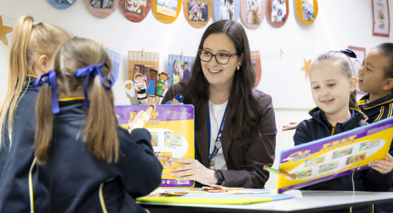 Teacher helping students with work.